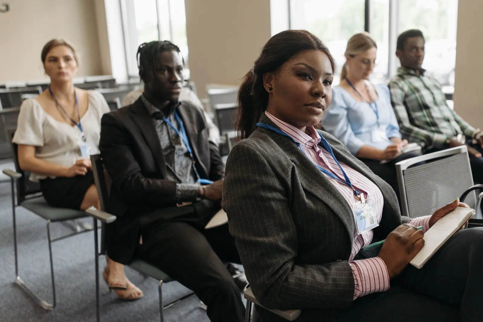 Adults listening and taking notes during a workshop