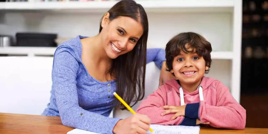 Child doing homework with a tutor