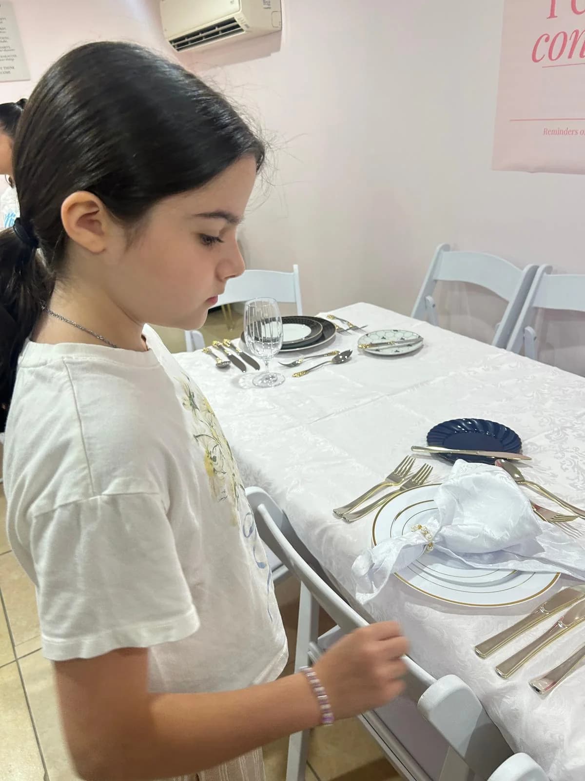 A student practices arranging a place setting