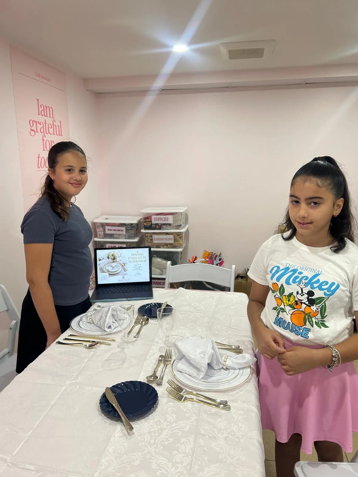 Two students taking part in a table manners activity