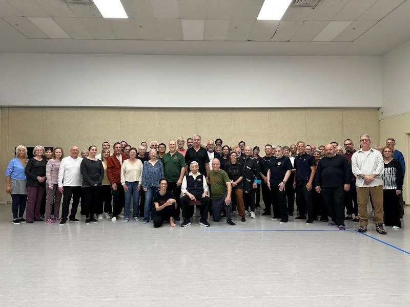 Tai Chi Chuan class members gathered together in a studio